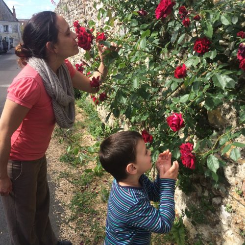 Woman and child smelling the roses