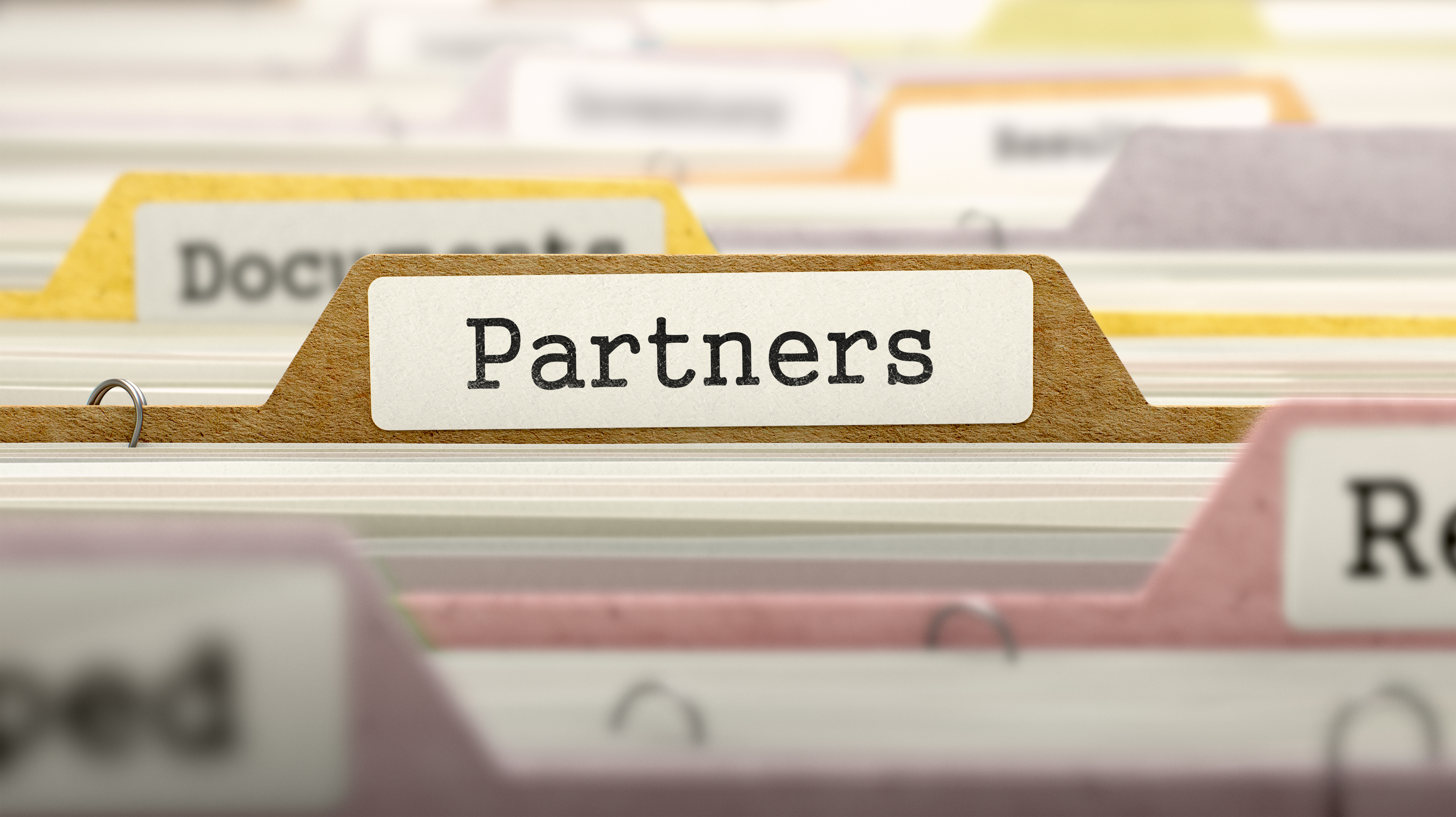Image of a folder labeled Partners in a folder drawer - represents that Knowing how to pick the best joint venture partners is a key ability to become a Property Millionaire