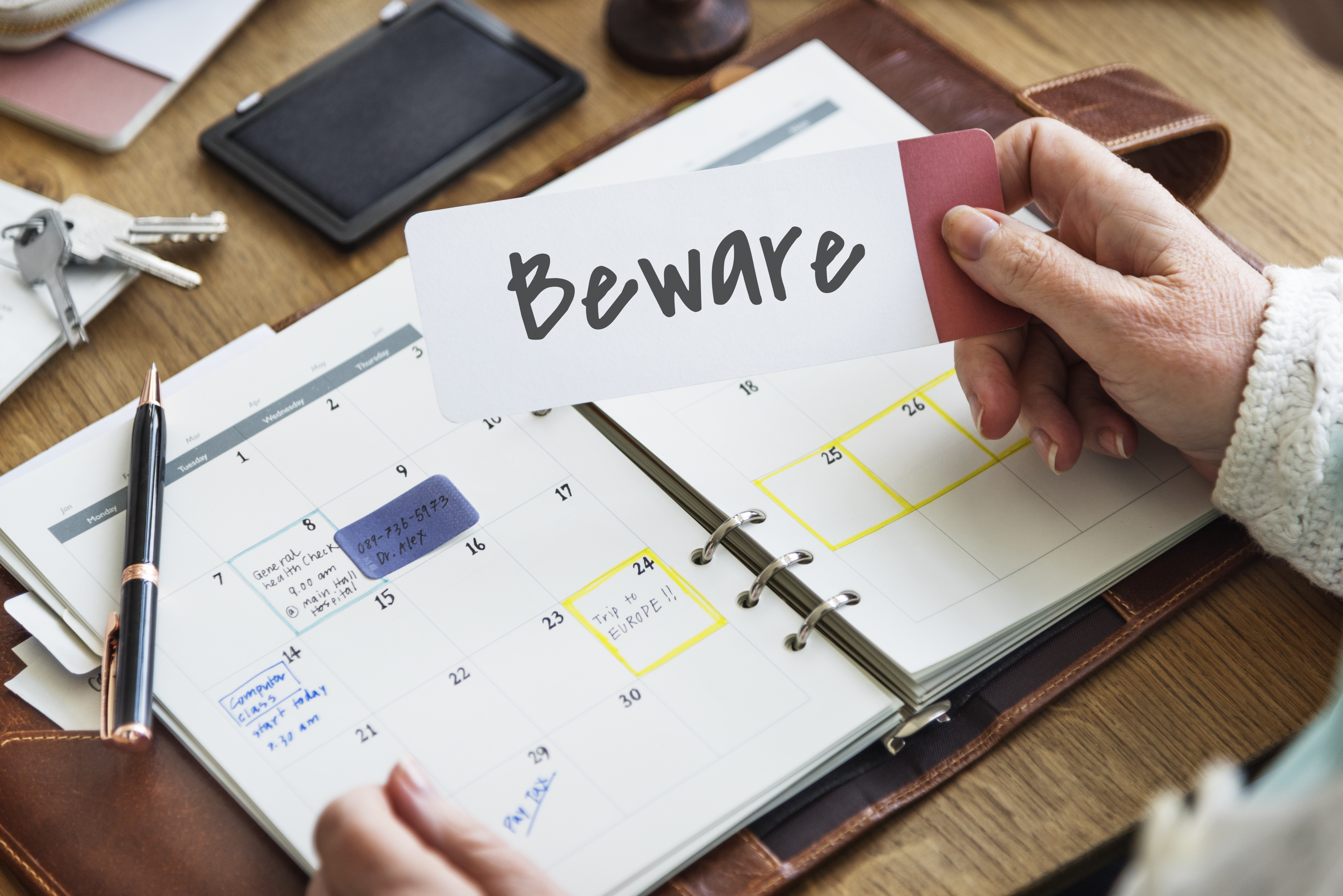 Image of someone holding a piece of paper with Beware written on it - represents that You need to be aware that It is not always easy to obtain development approval for your subdivision