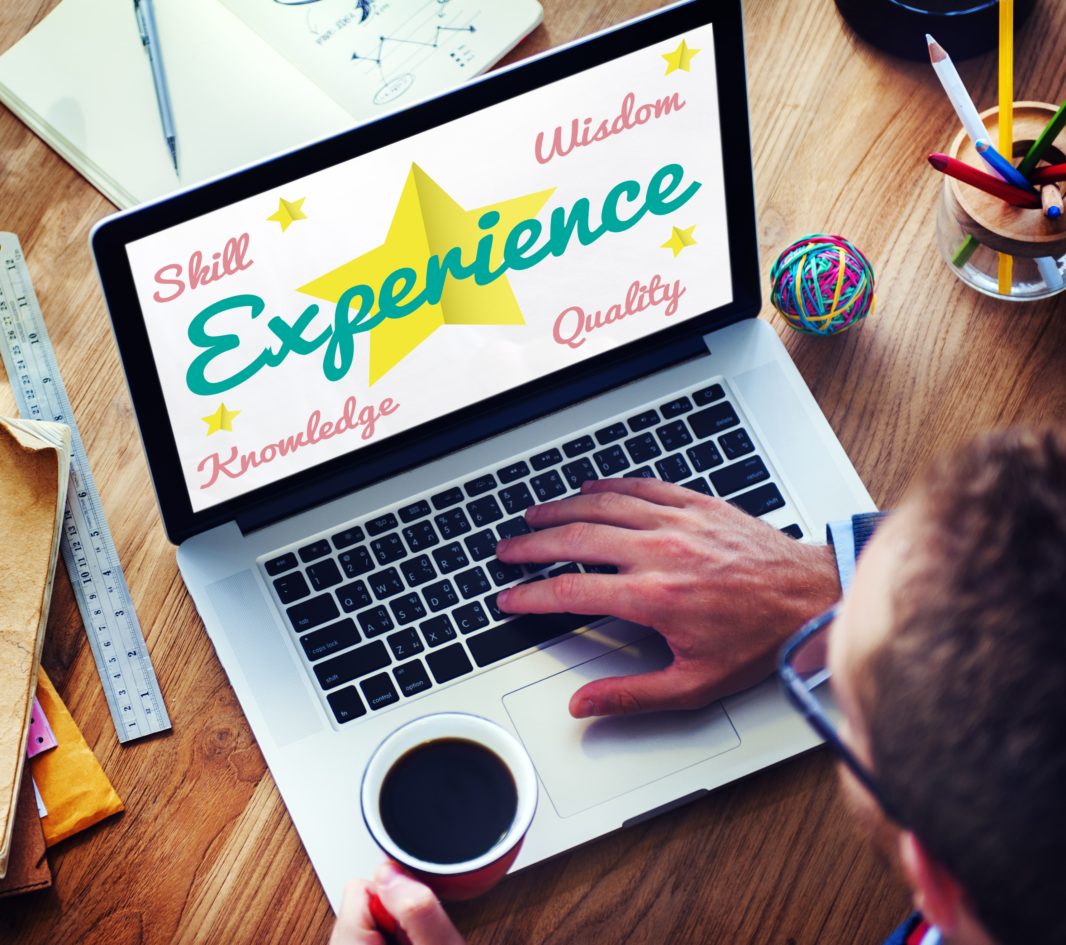 Picture of someone looking a computer screen with the word Experience written on it. Shows that A Property Investing Secrets is to use yout personal experience to your advantage
