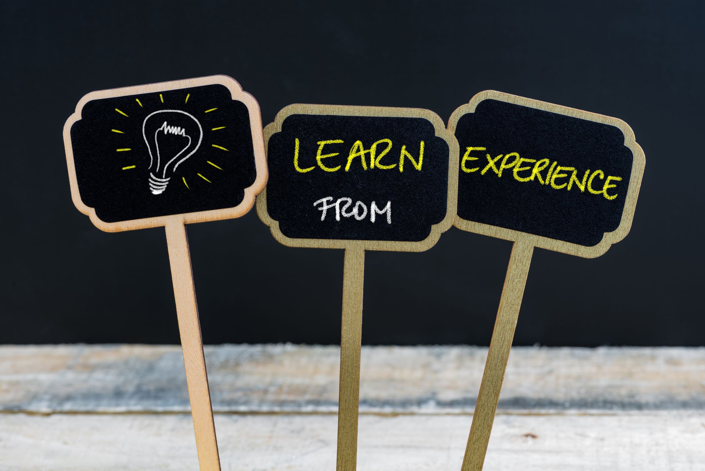Picture of 3 signs saying Learn from experience. represents that Learning from experience is a Property Investing Secret you should always remember