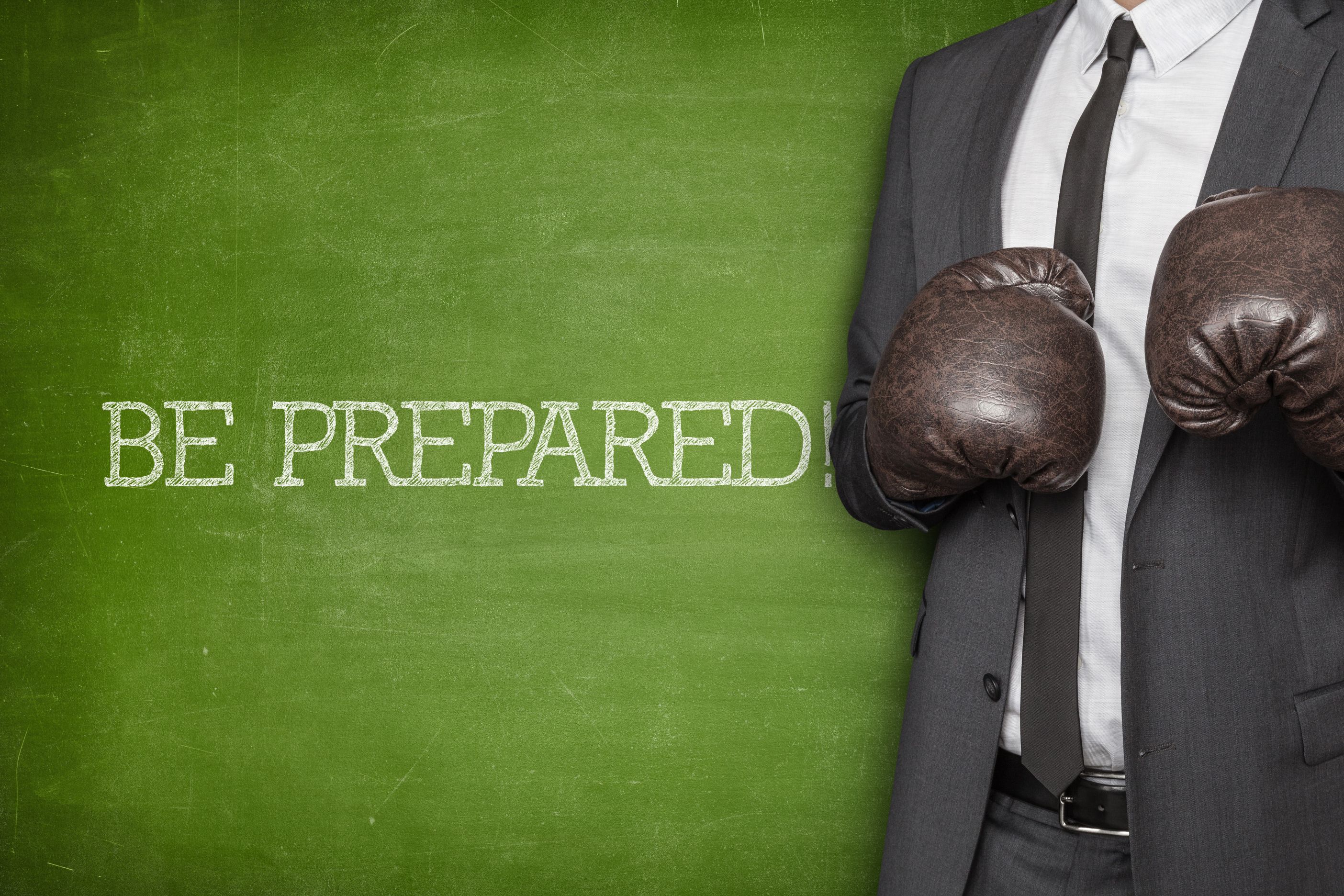 Picture of a business man wearing boxing gloves. Property Investing Secret Be prepared to anything