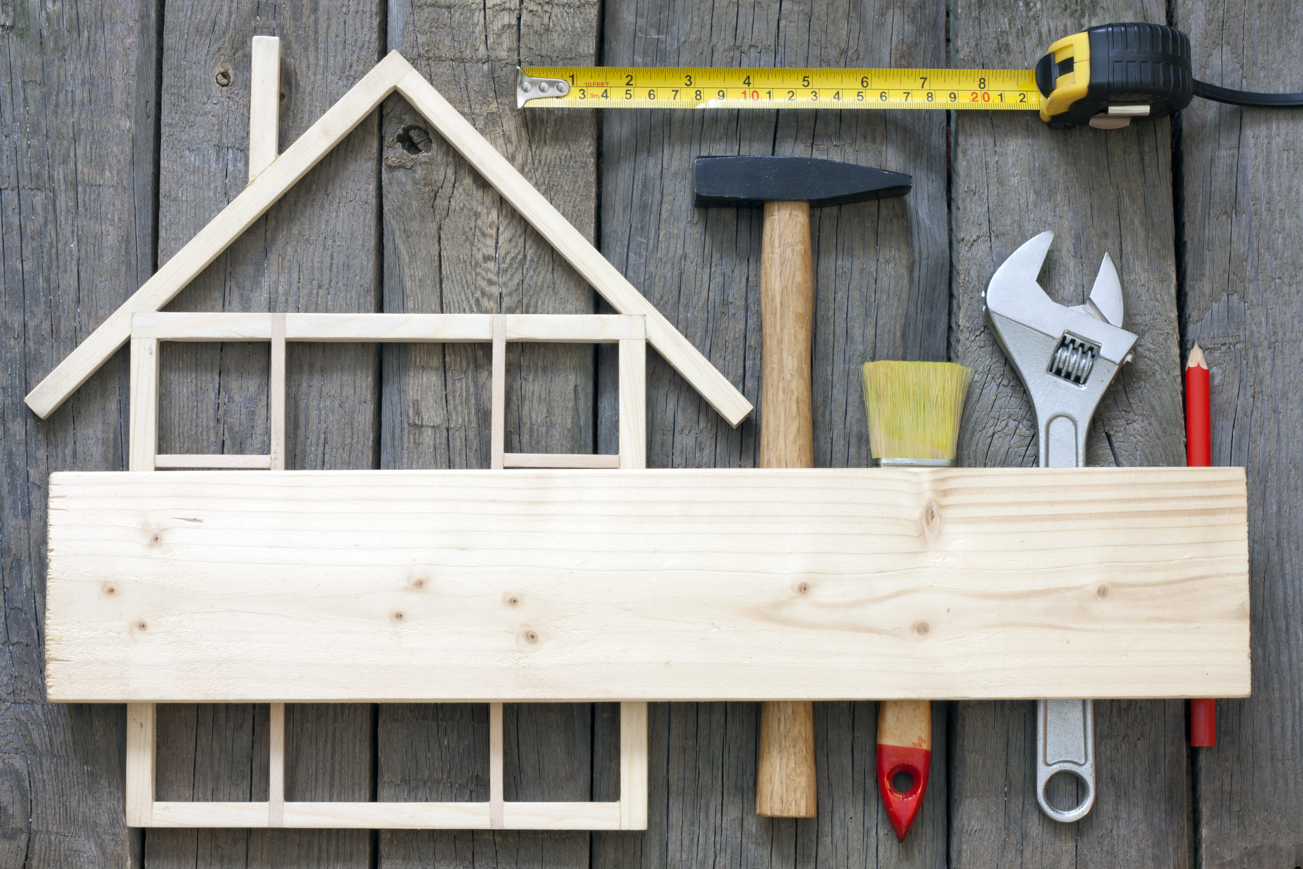 image of a wood made house frame and tool - raises the question if Renovation is the Right Property Investing Strategy For You